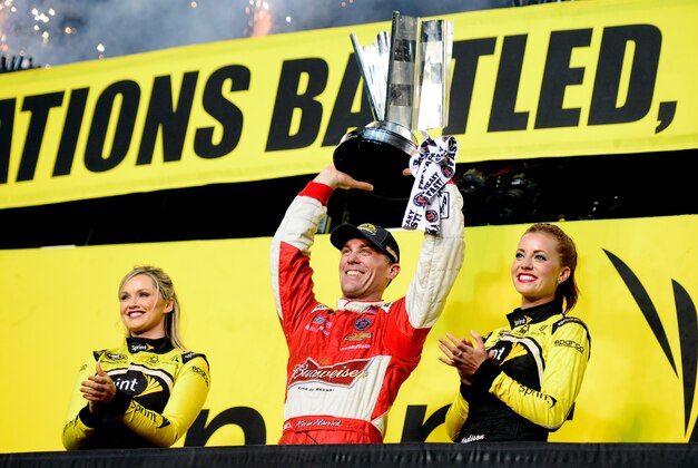 HOMESTEAD, FL - NOVEMBER 16:  Kevin Harvick, driver of the #4 Budweiser Chevrolet, celebrates with the trophy in Victory Lane after winning during the NASCAR Sprint Cup Series Ford EcoBoost 400 at Homestead-Miami Speedway on November 16, 2014 in Homestead, Florida.  (Photo by Robert Laberge/Getty Images)