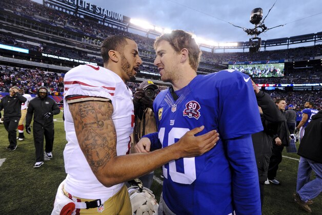 San Francisco 49ers quarterback Colin Kaepernick, left, and New York Giants quarterback Eli Manning (10) talk after an NFL football game Sunday, Nov. 16, 2014, in East Rutherford, N.J. The 49ers won the game 16-10. (AP Photo/Bill Kostroun)