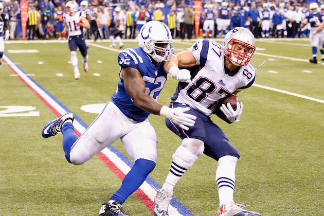 INDIANAPOLIS, IN - NOVEMBER 16:   Rob Gronkowski #87 of the New England Patriots breaks tackle with  D'Qwell Jackson #52 of the Indianapolis Colts before scoring a touchdown during the fourth quarter of the game at Lucas Oil Stadium on November 16, 2014 in Indianapolis, Indiana.  (Photo by Joe Robbins/Getty Images)
