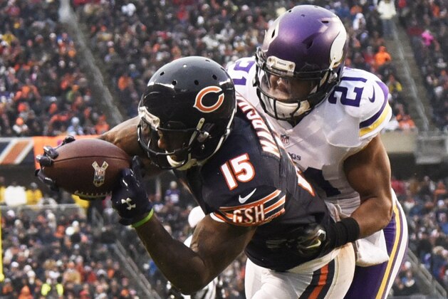 CHICAGO, IL - NOVEMBER 16: Brandon Marshall #15 of the Chicago Bears catches a touchdown pass over Josh Robinson #21 of the Minnesota Vikings during the fourth quarter of a game at Soldier Field on November 16, 2014 in Chicago, Illinois. (Photo by David Banks/Getty Images)