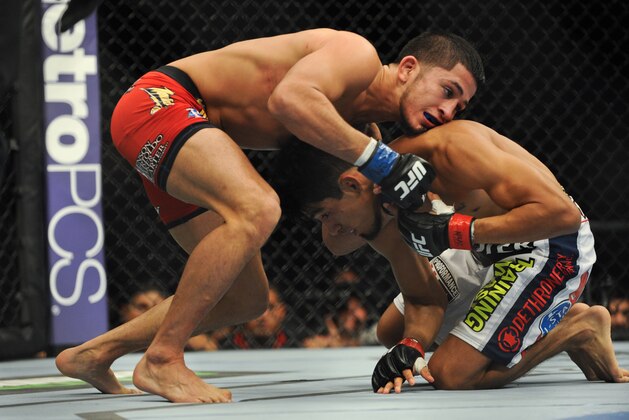 Nov 16, 2013; Las Vegas, NV, USA; Will Campuzano (red gloves) fights against Sergio Pettis (blue gloves) in their bantamweight bout during UFC 167 at MGM Grand Garden Arena. Mandatory Credit: Stephen R. Sylvanie-USA TODAY Sports