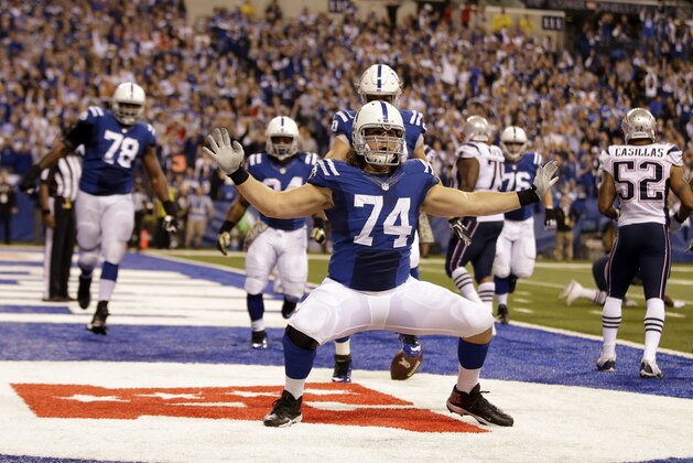 Indianapolis Colts tackle Anthony Castonzo celebrates after making a catch for a touchdown against the New England Patriots during the second half of an NFL football game in Indianapolis, Sunday, Nov. 16, 2014. (AP Photo/Darron Cummings)