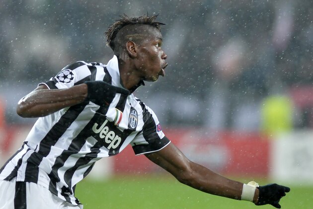 Juventus' Paul Pogba celebrates after scoring the third goal of his team during a Champions League, Group A soccer match between Juventus and Olympiakos, at the Juventus Stadium in Turin, Italy, Tuesday, Nov. 4, 2014. (AP Photo/Massimo Pinca)