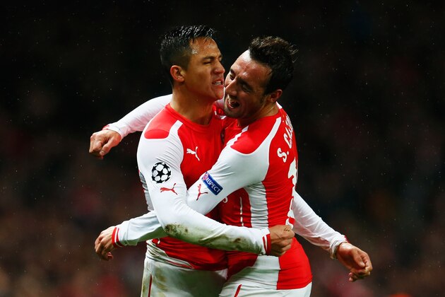 LONDON, ENGLAND - NOVEMBER 04:  Alexis Sanchez of Arsenal (L) celebrates with Santi Cazorla (R) as he scores their second goal during the UEFA Champions League Group D match between Arsenal FC and RSC Anderlecht at Emirates Stadium on November 4, 2014 in London, United Kingdom.  (Photo by Michael Regan/Getty Images)