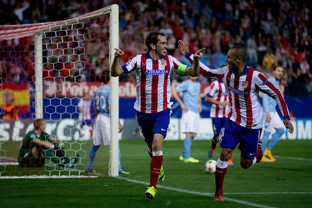 MADRID, SPAIN - OCTOBER 22:  Diego Godin (L) celebrates scoring their fourth goal with teammate Joao Miranda (R) during the UEFA Champions League group A match between Club Atletico de Madrid and Malmo FF at Vicente Calderon stadium on October 22, 2014 in Madrid, Spain.  (Photo by Gonzalo Arroyo Moreno/Getty Images)