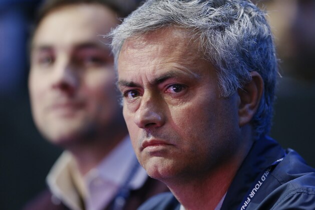 Chelsea soccer manager Jose Mourinho waits for the start of the singles ATP World Tour tennis finals match between Switzerland’s Roger Federer and Britain’s Andy Murray at the O2 arena in London, Thursday, Nov. 13, 2014. (AP Photo/Kirsty Wigglesworth)