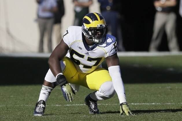 Michigan  defensive end Frank Clark (57) waits on the snap during the first half of an NCAA college football game against Michigan State in East Lansing, Mich., Saturday, Oct. 25, 2014. (AP Photo/Carlos Osorio)