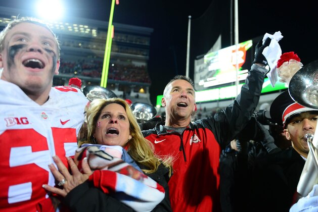 Nov 8, 2014; East Lansing, MI, USA; Ohio State Buckeyes offensive lineman Pat Elflein (65) celebrates with Shelly Meyer and Urban Meyer after defeating the Michigan State Spartans 49-37 at Spartan Stadium. Mandatory Credit: Andrew Weber-USA TODAY Sports