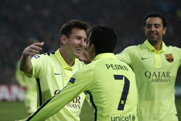 Barcelona's Lionel Messi celebrates with team mates scoring his side's 2nd goal during the Group F Champions League match between AFC Ajax and FC Barcelona at ArenA stadium in Amsterdam, Netherlands, Wednesday, Nov. 5, 2014. (AP Photo/Peter Dejong)