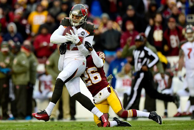 LANDOVER, MD - NOVEMBER 16: Wide receiver Mike Evans #13 of the Tampa Bay Buccaneers is tackled by cornerback Bashaud Breeland #26 of the Washington Redskins late in the third quarter at FedExField on November 16, 2014 in Landover, Maryland.  (Photo by Patrick McDermott/Getty Images)