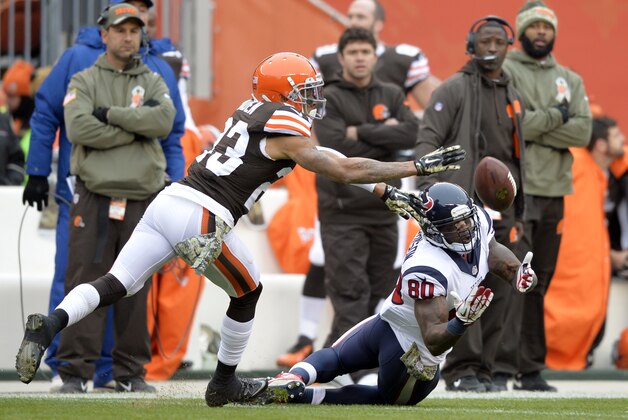 Houston Texans wide receiver Andre Johnson (80) reaches for a pass against Cleveland Browns cornerback Joe Haden in the first quarter of an NFL football game Sunday, Nov. 16, 2014, in Cleveland. (AP Photo/David Richard)