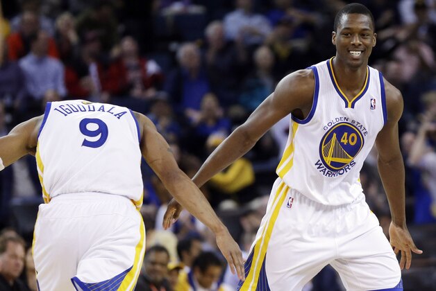 Golden State Warriors' Harrison Barnes celebrates with teammate Andre Iguodala during the second half of an NBA basketball game on Thursday, Feb. 6, 2014, in Oakland, Calif. Golden State won 102-87. (AP Photo/Marcio Jose Sanchez)