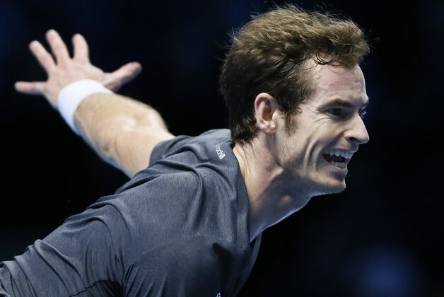 Britain’s Andy Murray serves to Switzerland’s Roger Federer during their singles ATP World Tour Finals tennis match at the O2 Arena in London, Thursday, Nov. 13, 2014. (AP Photo/Kirsty Wigglesworth)
