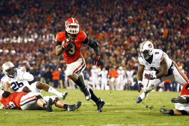 Georgia running back Todd Gurley (3) runs between Auburn linebacker Justin Garrett (26) and Auburn linebacker Cassanova McKinzy (8) to score a touchdown in the second half of an NCAA college football game Saturday, Nov. 15, 2014, in Athens, Ga. (AP Photo/John Bazemore)
