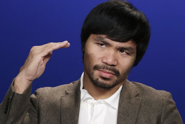 Boxer Manny Pacquiao gestures during an interview with The Associated Press, Friday, Sept. 5, 2014 in New York. Pacquiao takes on undefeated Chris Algieri in the gambling enclave of Macau on Nov. 22 for a piece of the welterweight title. The bout comes a year after the Filipino headlined the first big fight card there by beating Brandon Rios. (AP Photo/Mark Lennihan)
