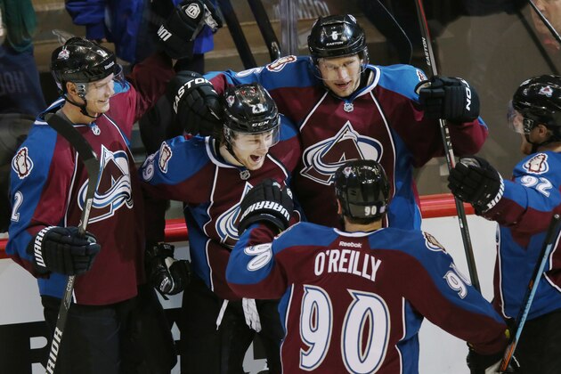 Clockwise from top left, Colorado Avalanche defenseman Nick Holden celebrates with center Nathan MacKinnon after his goal against the New York Islanders with defenseman Erik Johnson, left wing Gabriel Landeskog, of Sweden, and center Ryan O'Reilly in the second period of an NHL hockey game in Denver on Thursday, Oct. 30, 2014. (AP Photo/David Zalubowski)