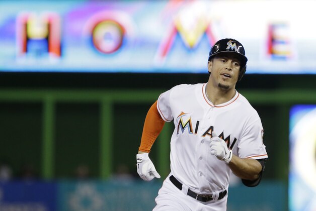 Miami Marlins' Giancarlo Stanton rounds second base after hitting a home run during the first inning of a baseball game against the New York Mets, Monday, Sept. 1, 2014 in Miami. (AP Photo/Wilfredo Lee)