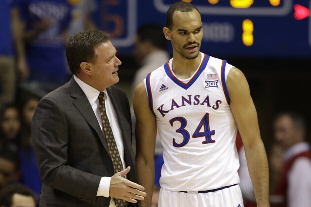 Kansas head coach Bill Self, left, and Perry Ellis (34) during the first half of an NCAA college basketball game against UC Santa Barbara in Lawrence, Kan., Friday, Nov. 14, 2014. (AP Photo/Orlin Wagner)