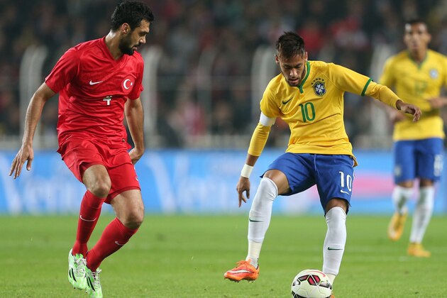 Brazil's Neymar JR, right, and Bekir Irtegun of Turkey fight for the ball during their friendly soccer match at Sukru Saracoglu Stadium in Istanbul, Turkey, Wednesday, Nov. 12, 2014. (AP Photo)