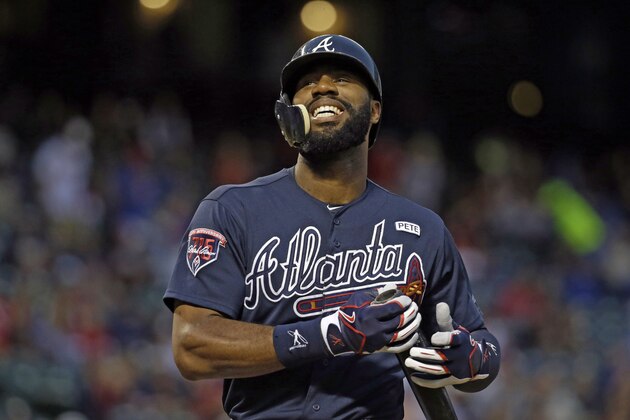 Atlanta Braves' Jason Heyward, who wears an extension to his helmet covering part of his face, grimaces after fouling a ball off of his foot during an at bat against Texas Rangers' Derek Holland in the first inning of a baseball game, Friday, Sept. 12, 2014, in Arlington, Texas. (AP Photo/Tony Gutierrez)