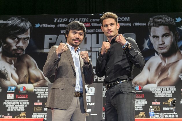 FILE - In this Sept. 3, 2014, file photo, boxers Manny Pacquiao, left, and Chris Algieri pose for a photo in Los Angeles. Algieri still lives at home with his parents, so a trip to China seems like a big deal. It will be even bigger if Algieri capitalizes on his improbable path to fame and beats Pacquiao this month.  (AP Photo/Damian Dovarganes, Filewld)