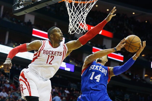 HOUSTON, TX - NOVEMBER 14:  Dwight Howard #12 of the Houston Rockets reaches to block a shot from K.J. McDaniels #14 of the Philadelphia 76ers at the Toyota Center on November 14, 2014 in Houston, Texas.  NOTE TO USER: User expressly acknowledges and agrees that, by downloading and/or using this photograph, user is consenting to the terms and conditions of the Getty Images License Agreement. (Photo by Scott Halleran/Getty Images)