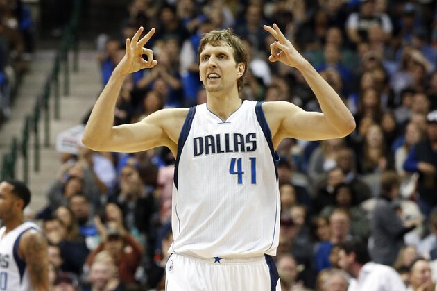 Dallas Mavericks' Dirk Nowitzki (41) of Germany signals a play to the offense during an NBA basketball game against the Sacramento Kings, Tuesday, Nov. 11, 2014, in Dallas. (AP Photo/Tony Gutierrez)