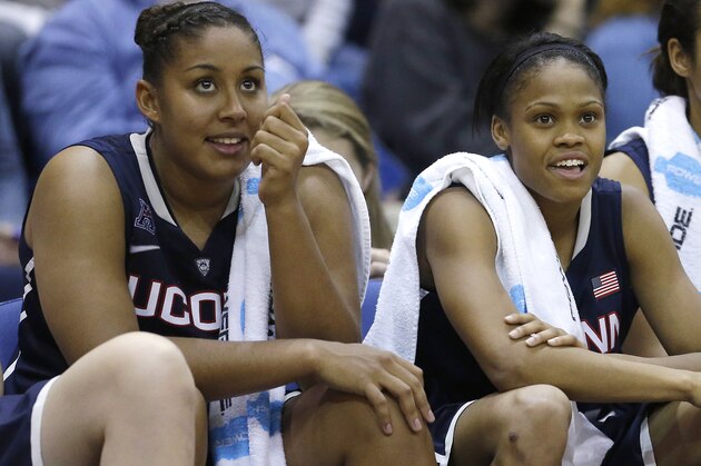 Connecticut's Kaleena Mosqueda-Lewis, left, and Moriah Jefferson smile as they watch the closing moments of the team's 102-43 win over UC Davis in an NCAA college basketball game in Davis, Calif., Friday, Nov. 14, 2014. (AP Photo/Rich Pedroncelli)