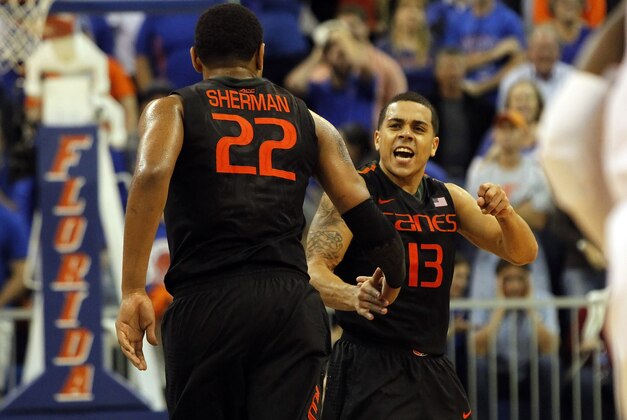 Nov 17, 2014; Gainesville, FL, USA; Miami Hurricanes forward Omar Sherman (22) and Miami Hurricanes guard Angel Rodriguez (13) congratulate each other against the Florida Gators during the second half at Stephen C. O'Connell Center. Miami Hurricanes defeated the Florida Gators 69-67. Mandatory Credit: Kim Klement-USA TODAY Sports