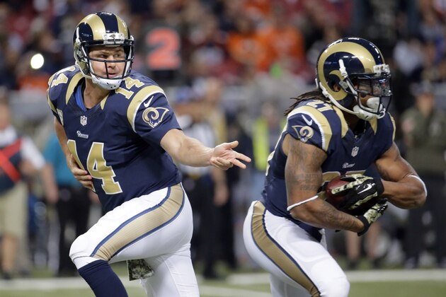 St. Louis Rams quarterback Shaun Hill, left, hands off to running back Tre Mason during the first quarter of an NFL football game against the Denver Broncos, Sunday, Nov. 16, 2014, in St. Louis. (AP Photo/Charlie Riedel)