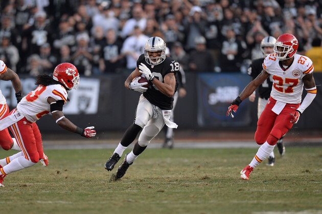 OAKLAND, CA - DECEMBER 15:  Andre Holmes #18 of the Oakland Raiders carries the ball against the Kansas City Cheifs during the third quarter at O.co Coliseum on December 15, 2013 in Oakland, California. The Cheifs won the game 56-31.  (Photo by Thearon W. Henderson/Getty Images)