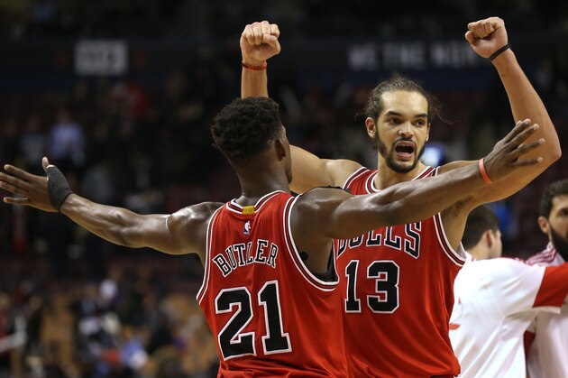 TORONTO,ON - NOVEMBER 13:  Joakim Noah #13 of the Chicago Bulls and Jimmy Butler #21 of the Chicago Bulls celebrate their win over the Toronto Raptors during their NBA game at the Air Canada Centre on November 13, 2014 in Toronto, Ontario, Canada. NOTE TO USER: User expressly acknowledges and agrees that, by downloading and/or using this photograph, user is consenting to the terms and conditions of the Getty Images License Agreement. Mandatory Copyright Notice: Copyright 2014 NBAE (Photo by Dave Sandford/NBAE via Getty Images)