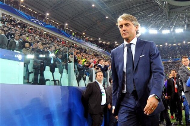 FIEL - In this file photo dated , Wednesday, Oct. 2, 2013, Galatasaray coach Roberto Mancini enters the Juventus Stadium, prior to the Champions League, Group B, soccer match between Juventus and Galatasaray, in Turin, Italy. Inter Milan has reappointed former coach Roberto Mancini, Friday Nov. 14, 2014, hours after firing Walter Mazzarri following a run of poor results.  (AP Photo/Massimo Pinca, FILE )