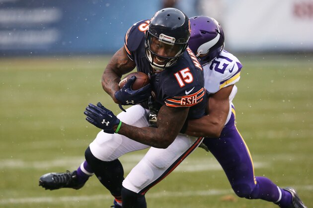 CHICAGO, IL - NOVEMBER 16: Brandon Marshall #15 of the Chicago Bears is tackled by Josh Robinson #21 of the Minnesota Vikings during the second quarter of a game at Soldier Field on November 16, 2014 in Chicago, Illinois. (Photo by Jonathan Daniel/Getty Images)