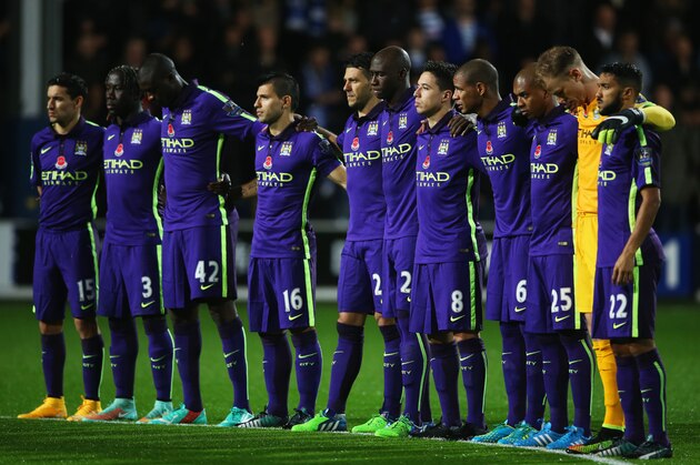 LONDON, ENGLAND - NOVEMBER 08:  Manchester City players observe a Remembrance Day silence prior to the Barclays Premier League match between Queens Park Rangers and Manchester City at Loftus Road on November 8, 2014 in London, England.  (Photo by Scott Heavey/Getty Images)