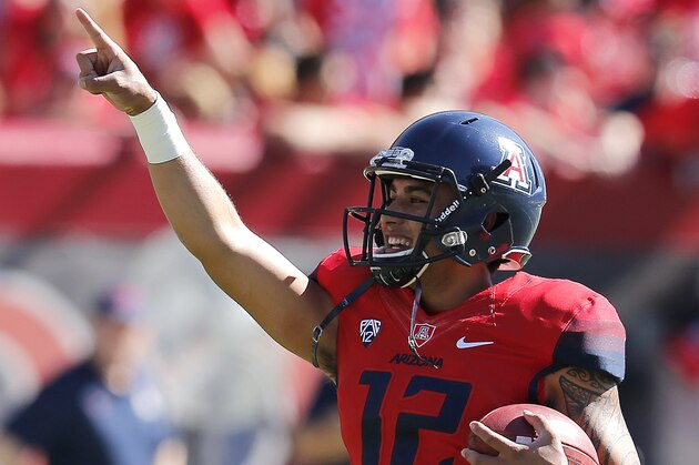 Arizona quarterback Anu Solomon (12) warms up before an NCAA college football game against Washington, Saturday, Nov. 15, 2014, in Tucson, Ariz. (AP Photo/Rick Scuteri)