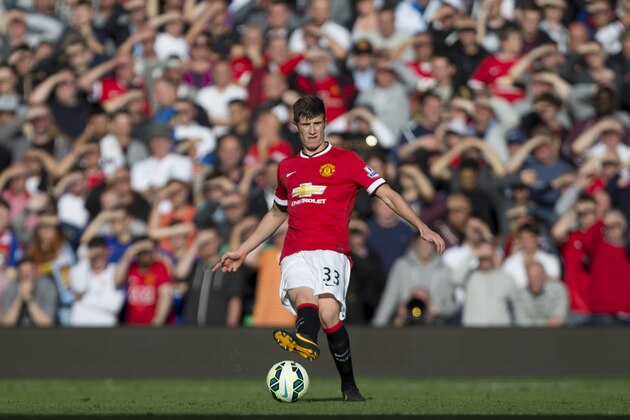 Manchester United's Patrick McNair passes the ball upfield during his team's English Premier League soccer match against West Ham United at Old Trafford Stadium, Manchester, England, Saturday Sept. 27, 2014. (AP Photo/Jon Super)
