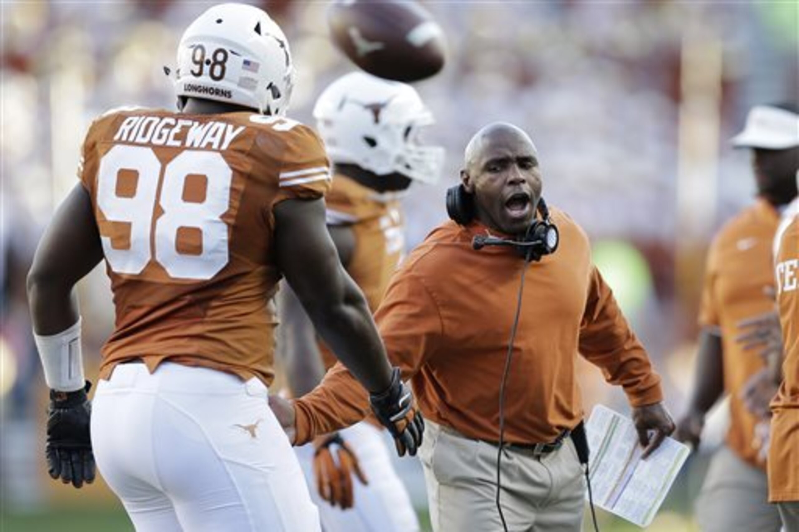 FILE - In this Nov. 8, 2014, file photo, Texas Longhorns head coach Charlie Strong, right, congratulates players as they walk off the field during the second half of an NCAA college football game against West Virginia in Austin, Texas. BOUND- Texas is bowl bound. That seemed such an unlikely scenario for first-year coach Charlie Strong when the Longhorns got shut out a month ago and were sinking fast. (AP Photo/Eric Gay, File) FILE - In this Nov. 8, 2014, file photo, Texas Longhorns head coach Charlie Strong, right, congratulates players as they walk off the field during the second half of an NCAA college football game against West Virginia in Austin, Texas. BOUND- Texas is bowl bound. That seemed such an unlikely scenario for first-year coach Charlie Strong when the Longhorns got shut out a month ago and were sinking fast. (AP Photo/Eric Gay, File)