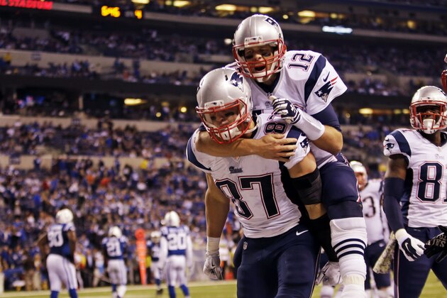 New England Patriots quarterback Tom Brady, top, jumps on the back of tight end Rob Gronkowski after Gronkowski scored a touchdown against the Indianapolis Colts during the second half of an NFL football game in Indianapolis, Sunday, Nov. 16, 2014. (AP Photo/AJ Mast)