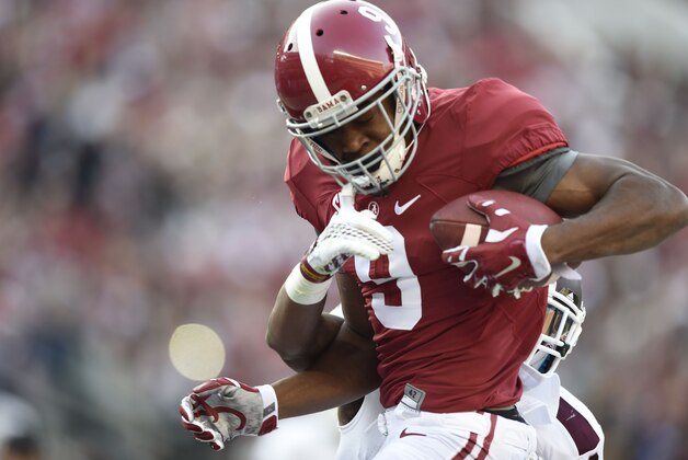 Nov 15, 2014; Tuscaloosa, AL, USA; Alabama Crimson Tide wide receiver Amari Cooper (9) catches a touchdown pass defended by Mississippi State Bulldogs defensive back Jay Hughes (3) in the second quarter at Bryant-Denny Stadium. Mandatory Credit: John David Mercer-USA TODAY Sports