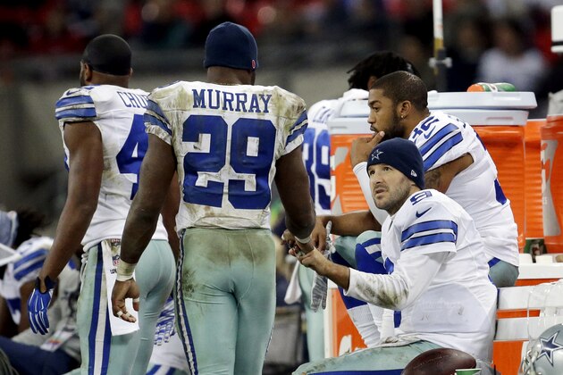 Dallas Cowboys quarterback Tony Romo talks to Dallas Cowboys running back DeMarco Murray during the second half of an NFL football game against the Jacksonville Jaguars at Wembley Stadium, London, Sunday, Nov. 9, 2014. The Cowboys defeated the Jaguars 31-17. (AP Photo/Matt Dunham)