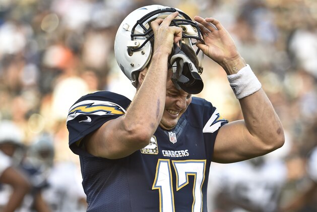 San Diego Chargers quarterback Philip Rivers rips off his helmet as he displays his frustration during the second half of the Chargers' 13-6 victory over the Oakland Raiders in an NFL football game Sunday, Nov. 16, 2014, in San Diego. The Chargers scored the game's only touchdown in the first minutes of the game.  (AP Photo/Denis Poroy)