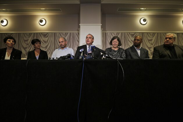 FILE - In this April 9, 2013, file photo, Attorney David Frederick, center, speaks during a news conference in Philadelphia, after a hearing to determine whether the NFL faces years of litigation over concussion-related brain injuries. Listening, from left Eleanor Perfetto, the widow of former NFL player Ralph Wenzel; Lisa McHale, the widow of former NFL player Tom McHale; former NFL player Kevin Turner, Frederick, Mary Ann Easterling, the widow of former NFL player Ray Easterling, and former NFL players Dorsey Levens, and Bill Bergey.  Judge Anita Brody has announced on Thursday, Aug. 29, 2013, that the NFL and more than 4,500 former players want to settle concussion-related lawsuits for $765 million. (AP Photo/Matt Rourke, File)