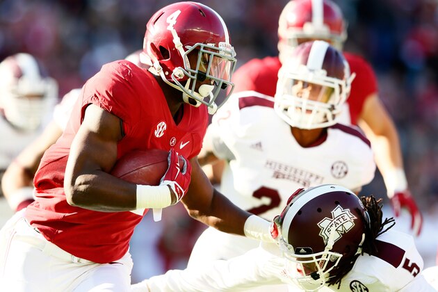 TUSCALOOSA, AL - NOVEMBER 15:  T.J. Yeldon #4 of the Alabama Crimson Tide stiff arms Jamerson Love #5 of the Mississippi State Bulldogs at Bryant-Denny Stadium on November 15, 2014 in Tuscaloosa, Alabama.  (Photo by Kevin C. Cox/Getty Images)