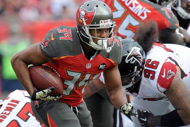 TAMPA, FL - NOVEMBER 09: Charles Sims #34 of the Tampa Bay Buccaneers carries during the second quarter of the game against the Atlanta Falcons at Raymond James Stadium on November 9, 2014 in Tampa, Florida. (Photo by Cliff McBride/Getty Images)
