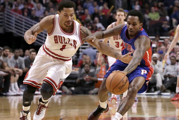 Chicago Bulls guard Derrick Rose (1) battles Detroit Pistons guard Brandon Jennings (7) for a loose ball during the second half of an NBA basketball game Monday, Nov. 10, 2014, in Chicago. The Bulls won 102-91. (AP Photo/Charles Rex Arbogast)