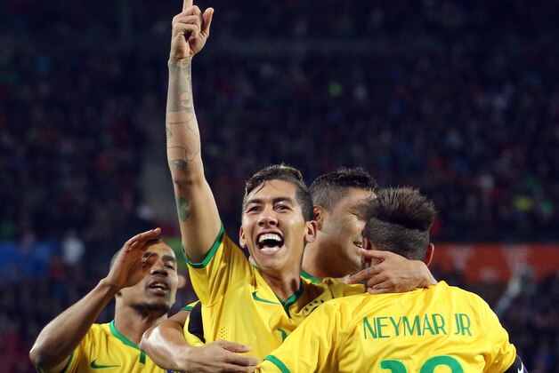 Brazil's players react after scoring during an International friendly soccer match between Austria and Brazil in Vienna, Austria, Tuesday, Nov. 18, 2014. (AP Photo/Ronald Zak)
