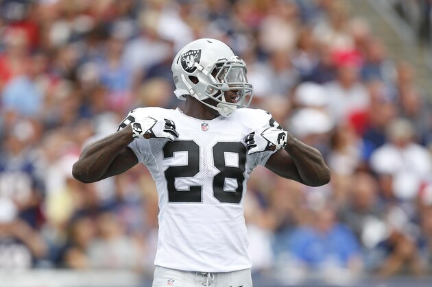 Oakland Raiders running back Latavius Murray (28) adjusts his pads prior to a play during an NFL game against the New England Patriots at Gillette Stadium in Foxborough, Mass. on Sunday, Sept. 21, 2014 . (Chris Keane/AP Images for Panini)