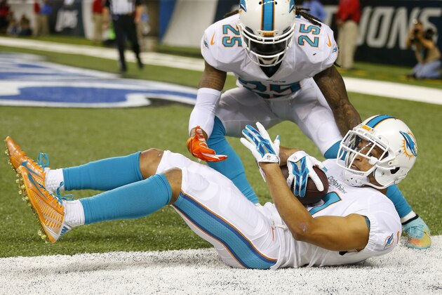 Miami Dolphins cornerback Brent Grimes (21) makes an interception against the Detroit Lions during an NFL football game, Sunday, Nov. 9, 2014, in Detroit. (Jeff Haynes/AP Images for Panini)