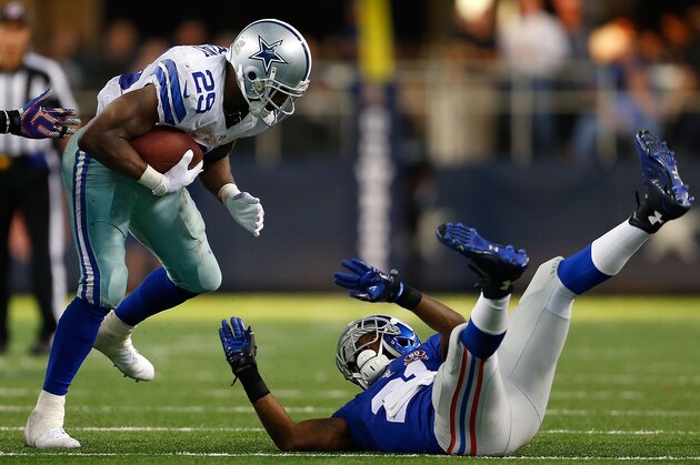 ARLINGTON, TX - OCTOBER 19:  DeMarco Murray #29 of the Dallas Cowboys runs over Dominique Rodgers-Cromartie #21 of the New York Giants in the second half at AT&T Stadium on October 19, 2014 in Arlington, Texas.  (Photo by Wesley Hitt/Getty Images)
